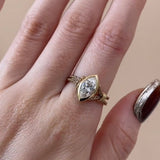 Close-up detail of the Marquise Flexible Wrap Ring, highlighting the D-F color diamond and the intricate texture of the 1.59mm gold chain.