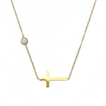The complete delicate gold chain featuring an off-center sideways cross, shown against a clean white background.
