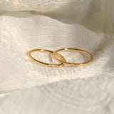 The 3-piece 18K gold plated stackable ring set arranged aesthetically to show their individual designs.