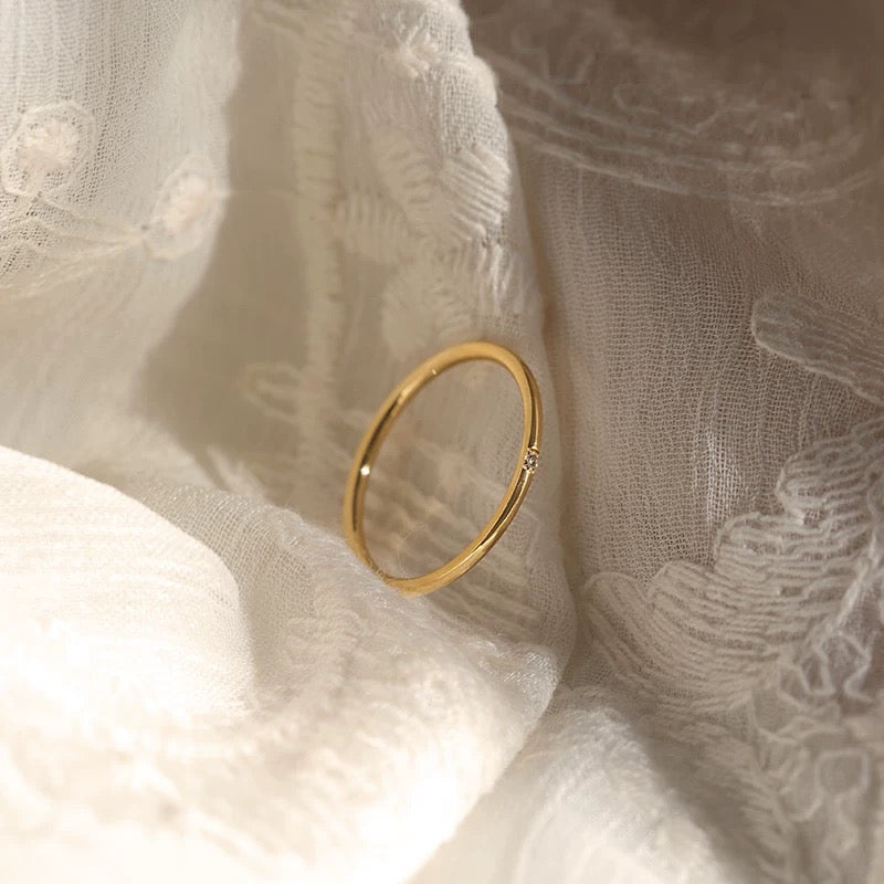 Close-up detail of the Essential Stacking Ring Trio, highlighting the intricate craftsmanship of the different gold bands.