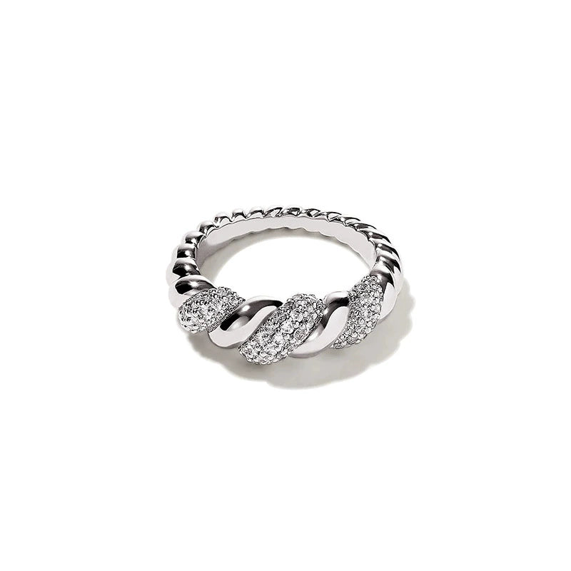 A high-end product shot of a 925 sterling silver twist link ring with sparkling pavé gemstone sections.