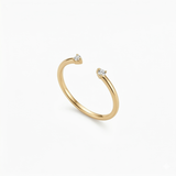 A high-quality product shot of a minimalist 18K gold-plated open cuff gap ring with two sparkling stones.