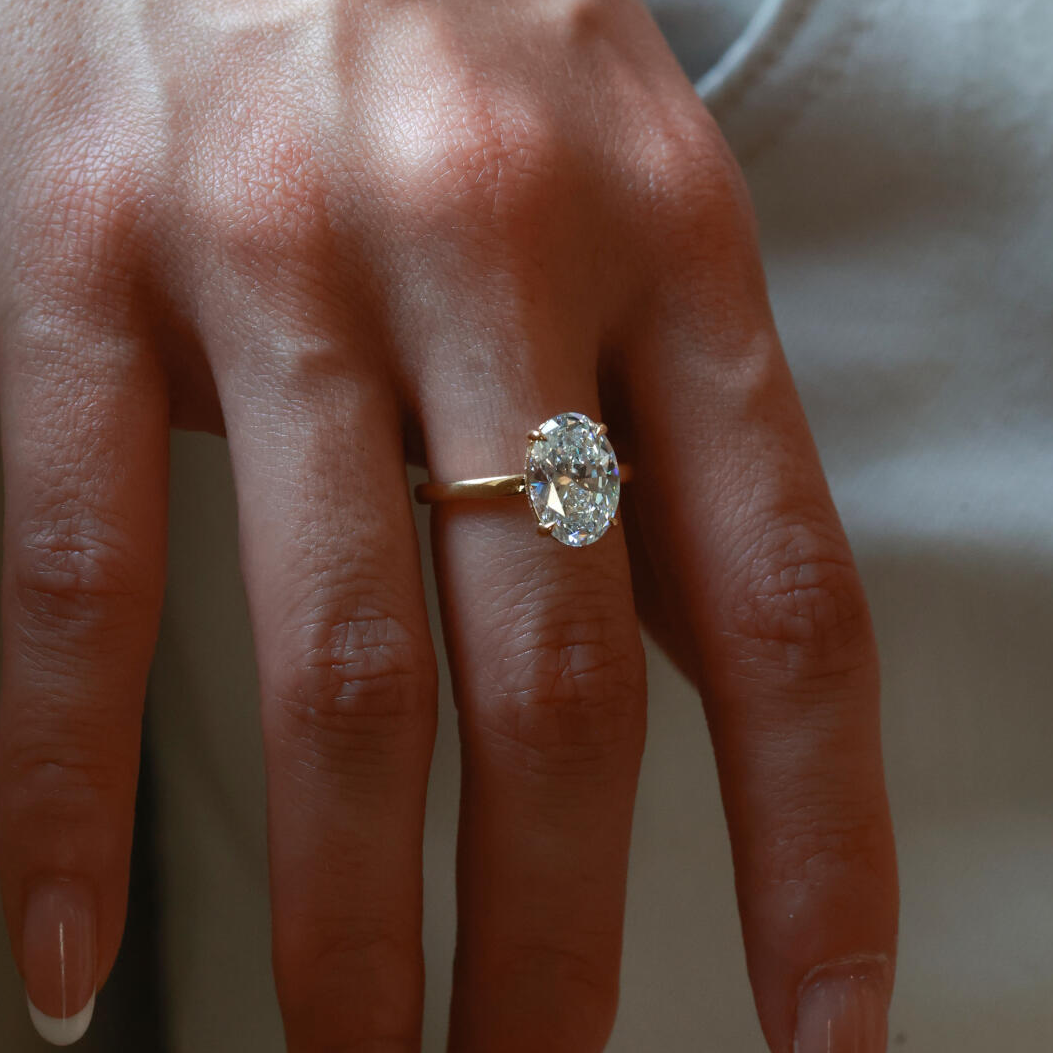 Close-up detail of the ultra-slim four-prong basket setting with an open gallery, optimizing light return for the ice-flower cut diamond.