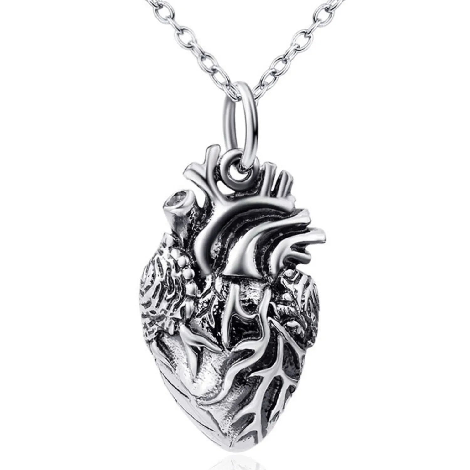 Macro detail shot of the 3D anatomical heart pendant on a white background, showcasing the realistic arteries and oxidized silver texture.