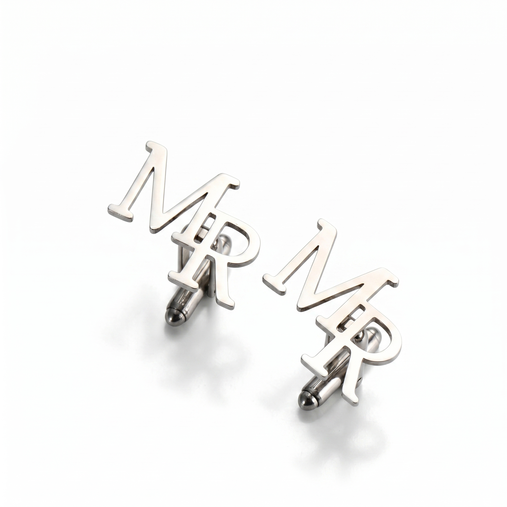 Silver 'MR' cufflinks on a white background