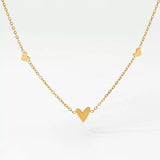 Detailed view of the Petite Love necklace highlighting the solid 6mm center heart and 3mm side heart charms.