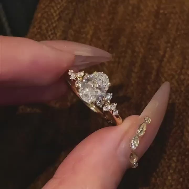 Three variations of the Shooting Star Spark ring (Oval, Round, and Cushion cuts) held in a hand to show the celestial design options.
