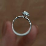 A woman's hand modeling the 2.06 ct oval halo diamond ring, highlighting its elegant proportions and brilliant sparkle.
