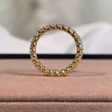 Detailed front view of the full eternity ring, highlighting the shared-prong basket setting and the D-E color oval lab diamonds.