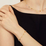 Model wearing the matching 18K gold plated Spectrum Gemstone necklace and bracelet.