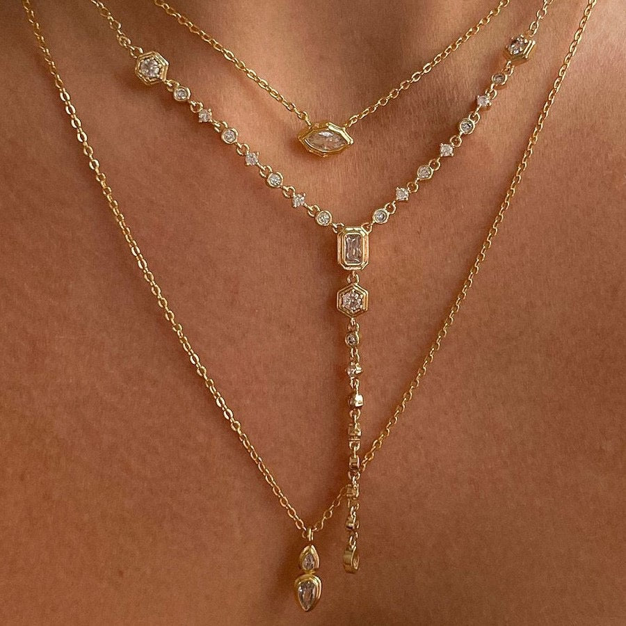 Model wearing the complete 3-piece Trinity Gemstone Layering Necklace Set in 18K gold.