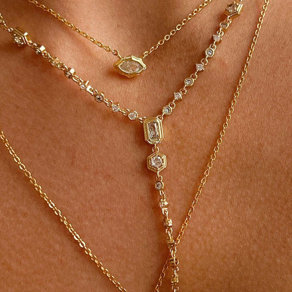 Model wearing the complete 3-piece Trinity Gemstone Layering Necklace Set in 18K gold.