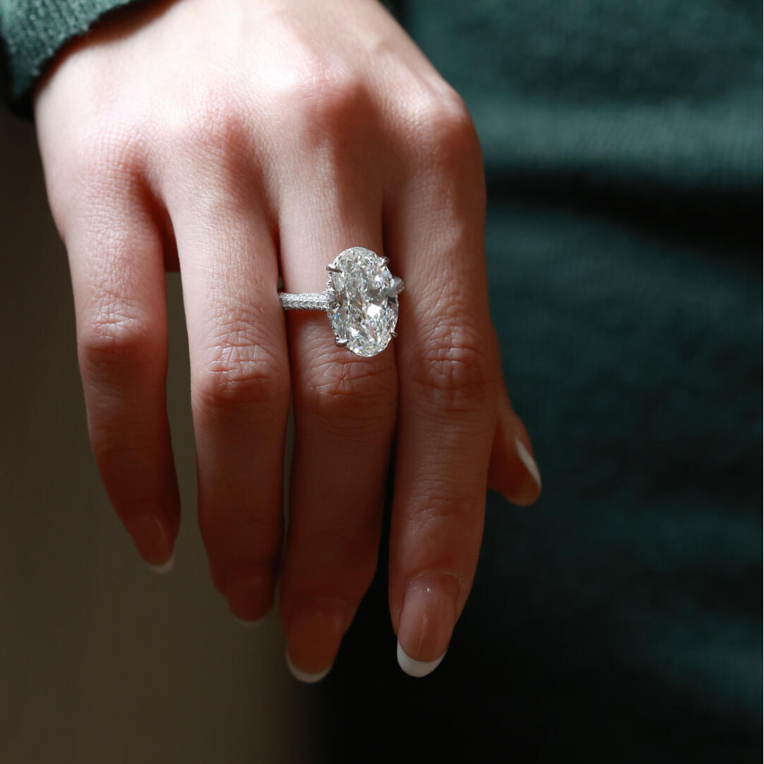 Close-up view of the oversized oval lab diamond ring, highlighting the luxurious triple-row micro-pavé eternity band.
