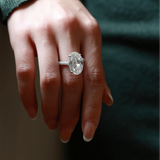Close-up view of the oversized oval lab diamond ring, highlighting the luxurious triple-row micro-pavé eternity band.