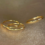 Close-up detail of the Essential Stacking Ring Trio, highlighting the intricate craftsmanship of the different gold bands.2