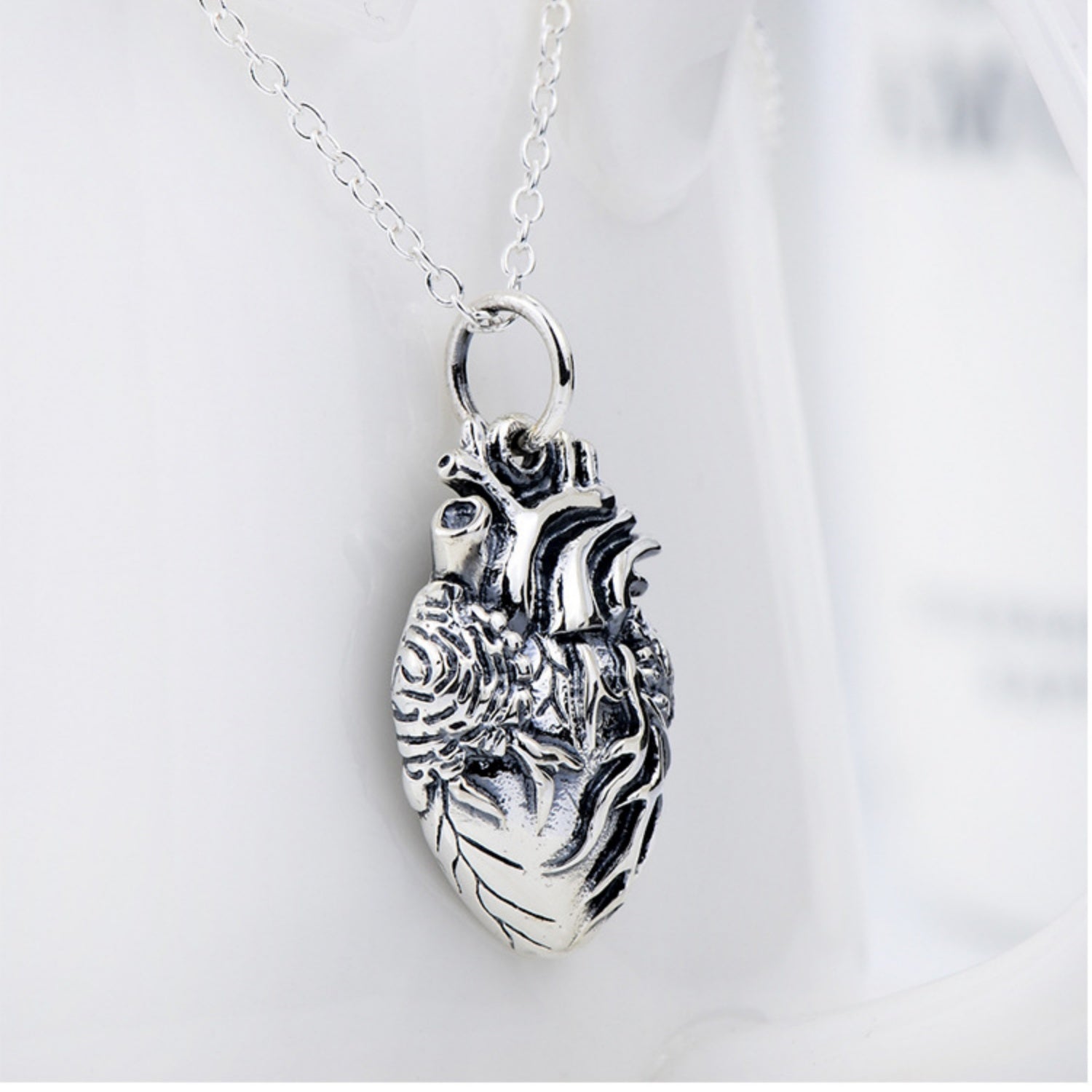 Close-up view of the solid 925 sterling silver anatomical heart charm with an antique finish, isolated on a clean white background.