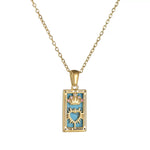 Close-up of an 18K gold plated tarot card pendant labeled THE EMPRESS, showcasing its turquoise enamel background, pink-jeweled crown, and sunburst heart design.
