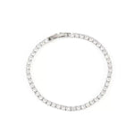 Top-down product photograph of a sleek white gold diamond tennis bracelet on a clean white background.
