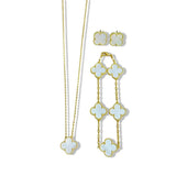 An elegant 18K gold plated jewelry set featuring a black four-leaf clover necklace, matching bracelet, and stud earrings laid on a white background.