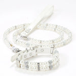An elegant white simulated pearl pet collar displayed together with a matching white pearl leash.
