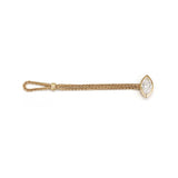Flat lay of the 18K gold woven chain ring demonstrating the innovative flexible loop closure and brilliant bezel-claw set marquise diamond.